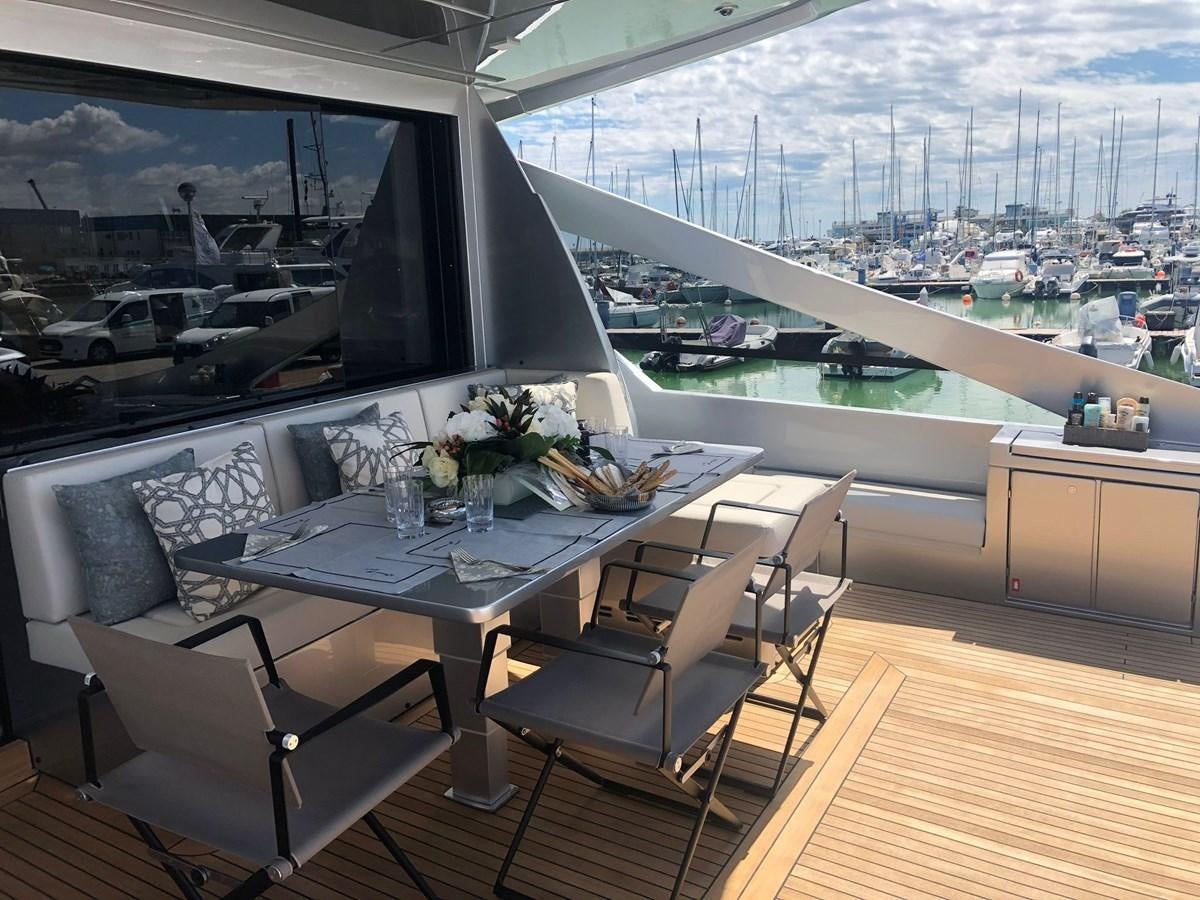 a room with a table and chairs aboard QUEEN B SPORT Yacht for Sale