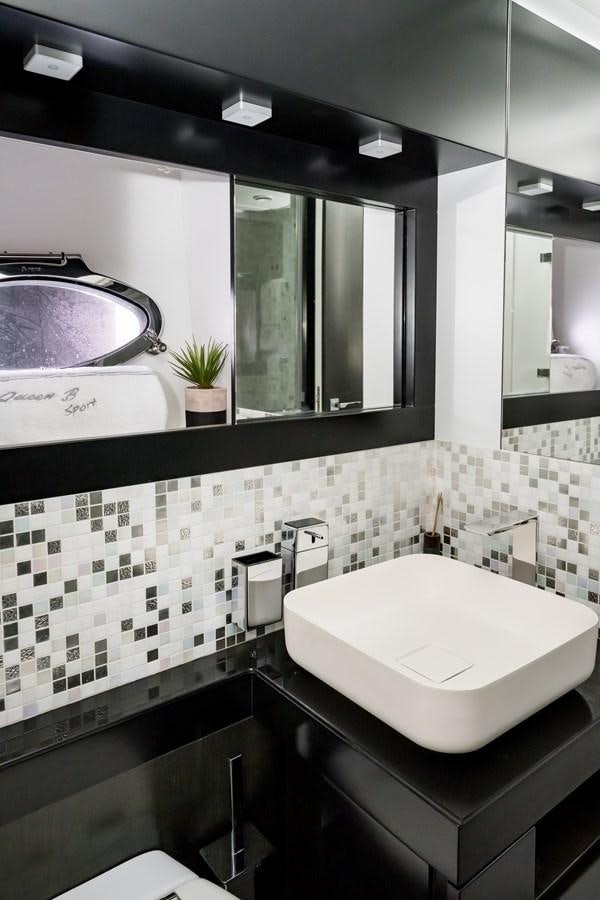 a bathroom with a large mirror aboard QUEEN B SPORT Yacht for Sale