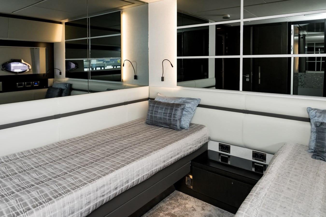 a room with a bed and a couch aboard QUEEN B SPORT Yacht for Sale
