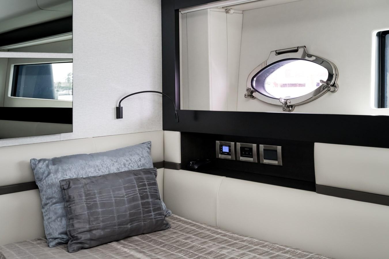 a room with a bed and a television aboard QUEEN B SPORT Yacht for Sale