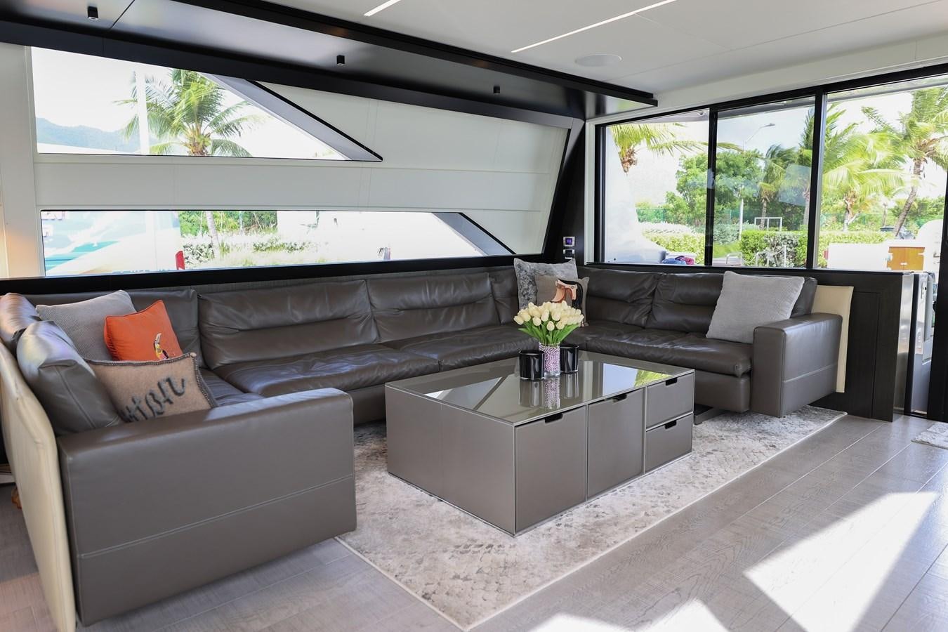 a living room with a couch and a coffee table aboard QUEEN B SPORT Yacht for Sale