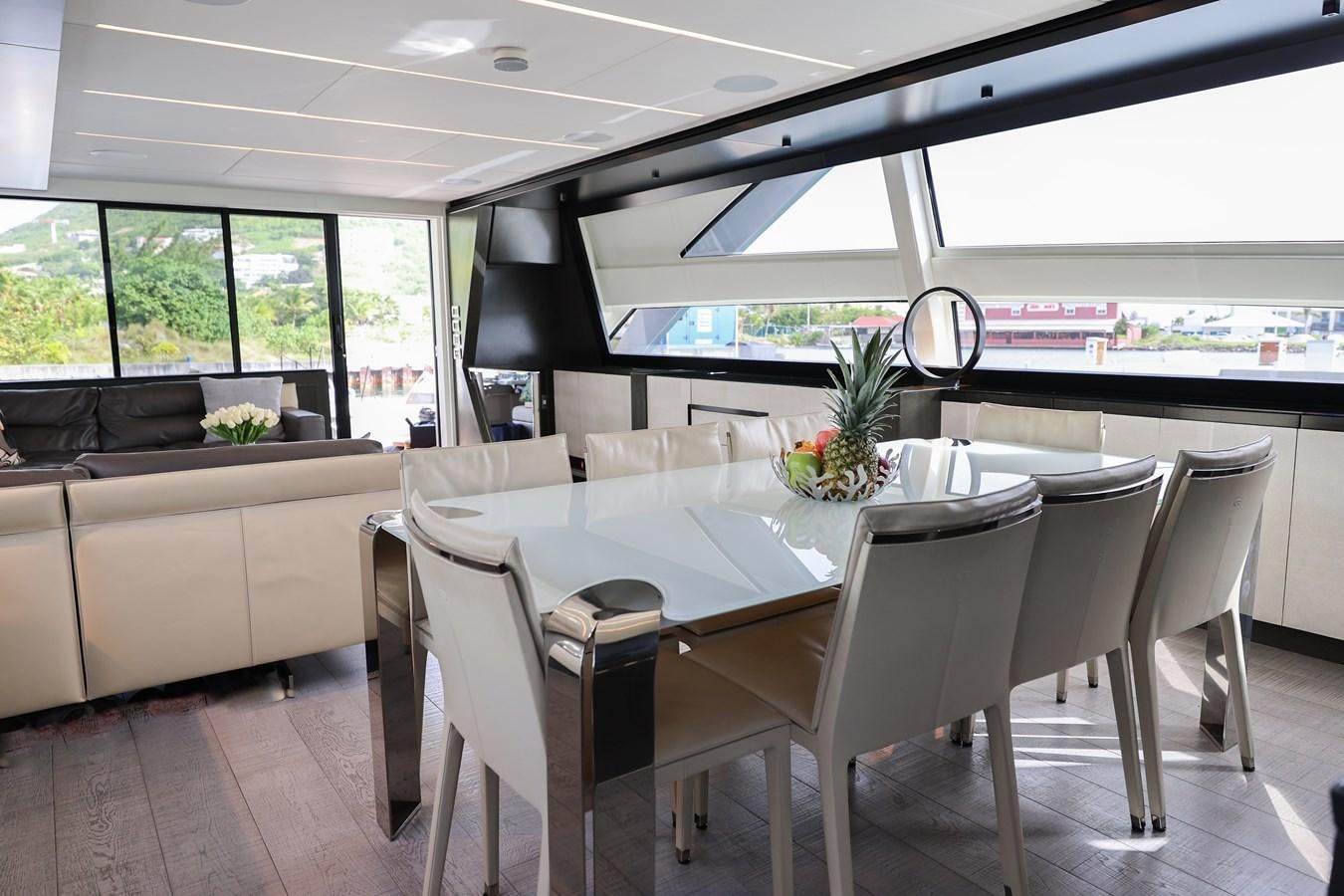 a dining room with a table and chairs aboard QUEEN B SPORT Yacht for Sale
