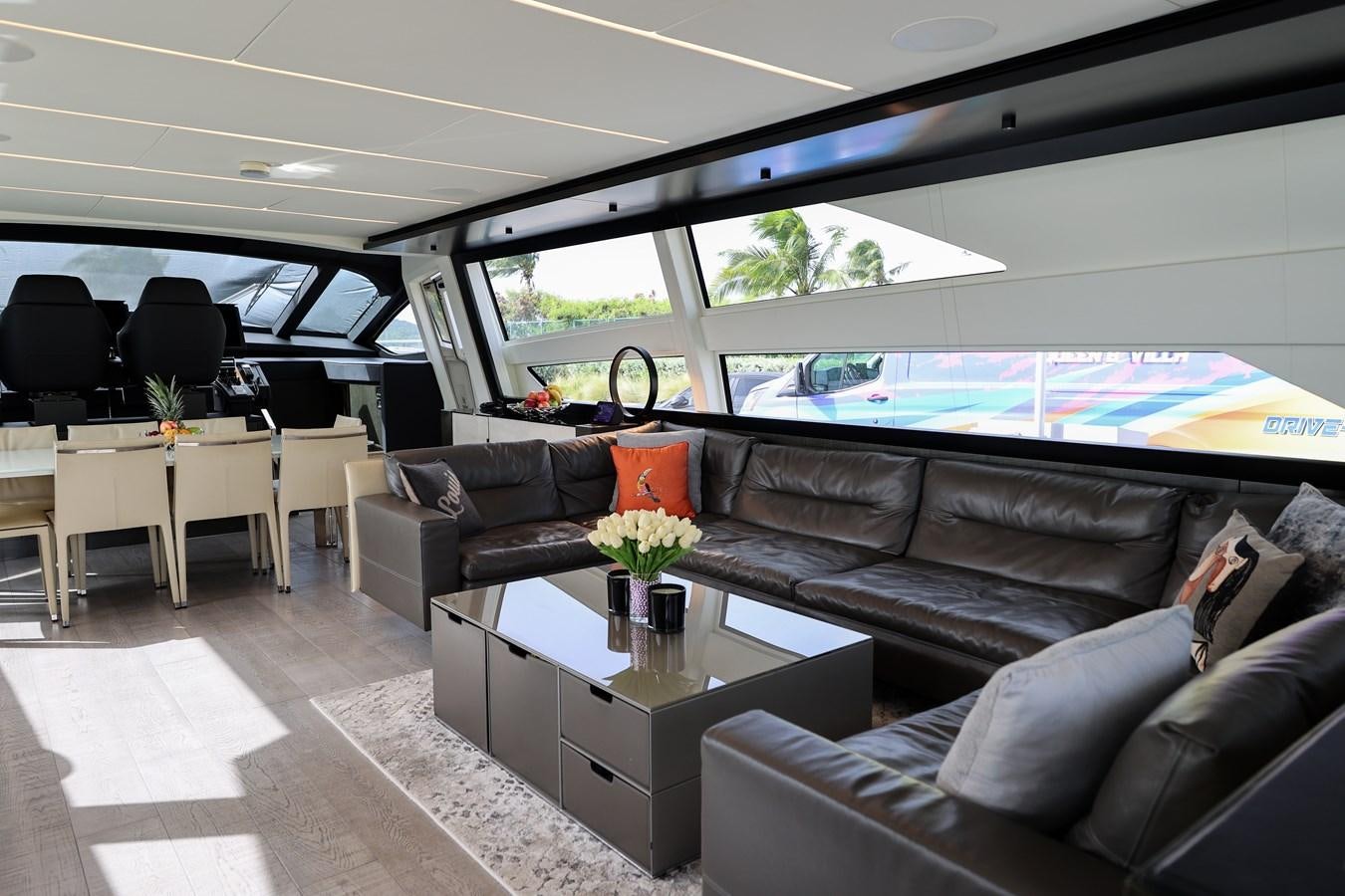 a living room with a large window aboard QUEEN B SPORT Yacht for Sale