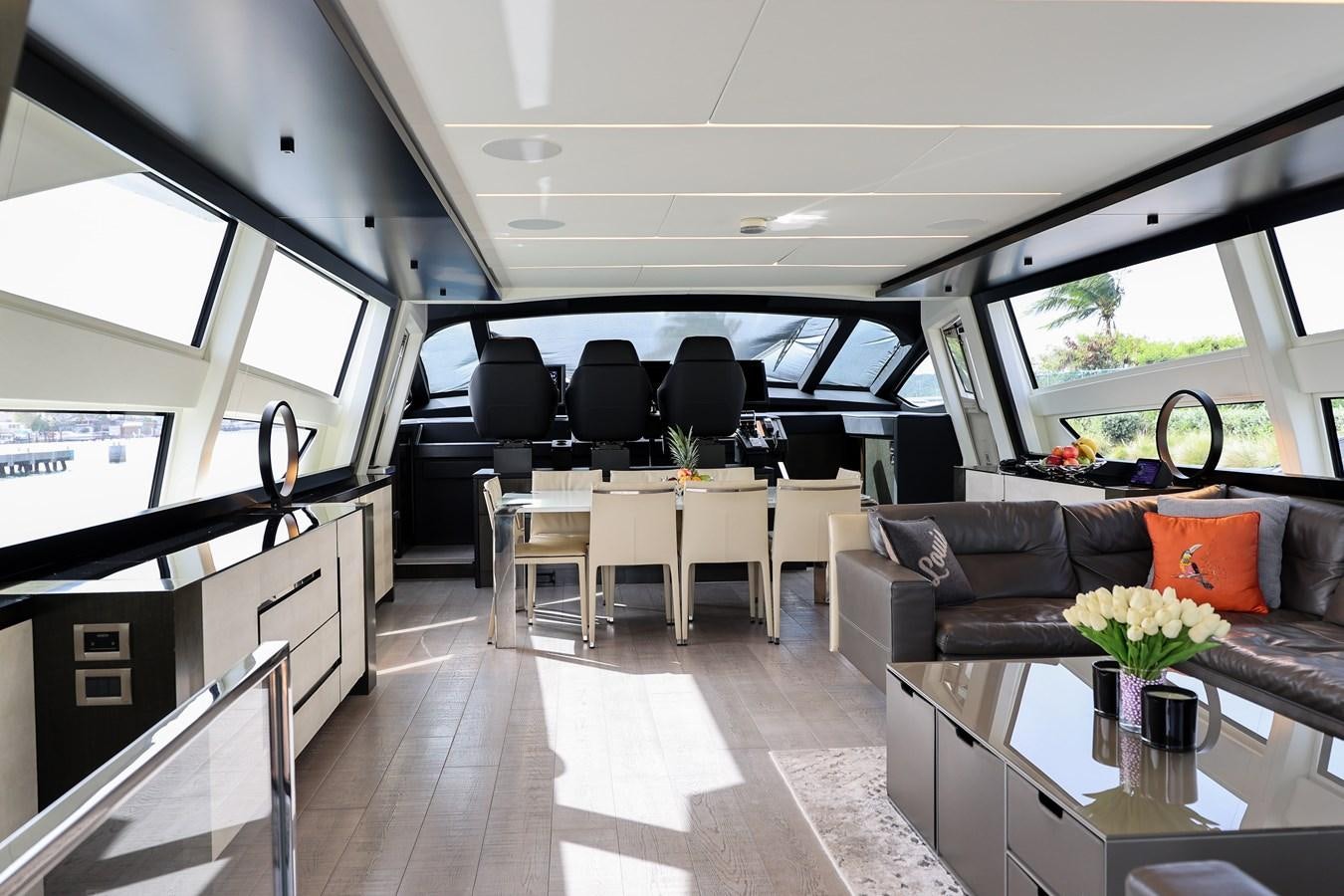 inside of a vehicle with a table and chairs and a couch aboard QUEEN B SPORT Yacht for Sale