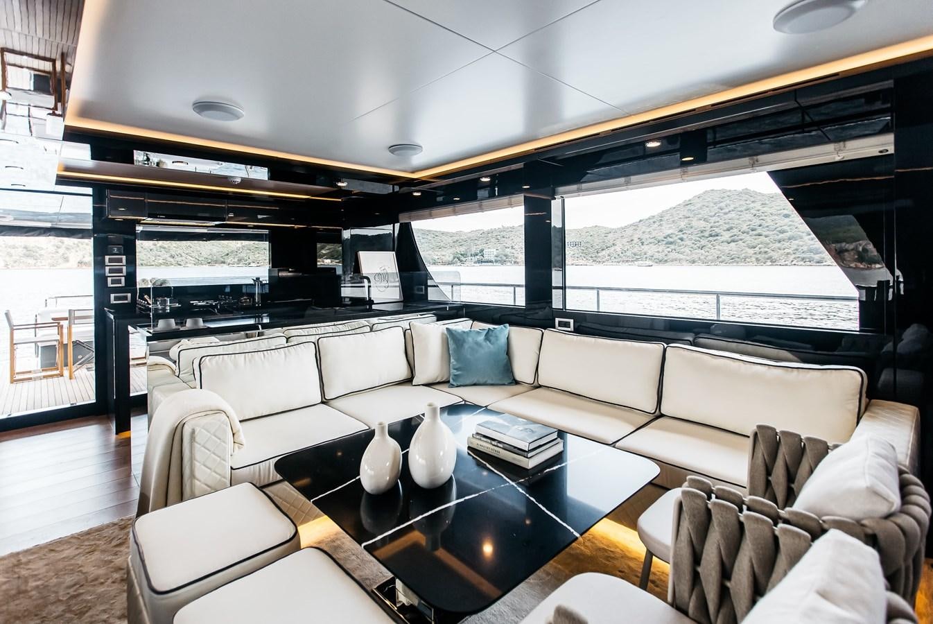 a living room with a large glass wall aboard BERING 70 LEVANNA Yacht for Sale