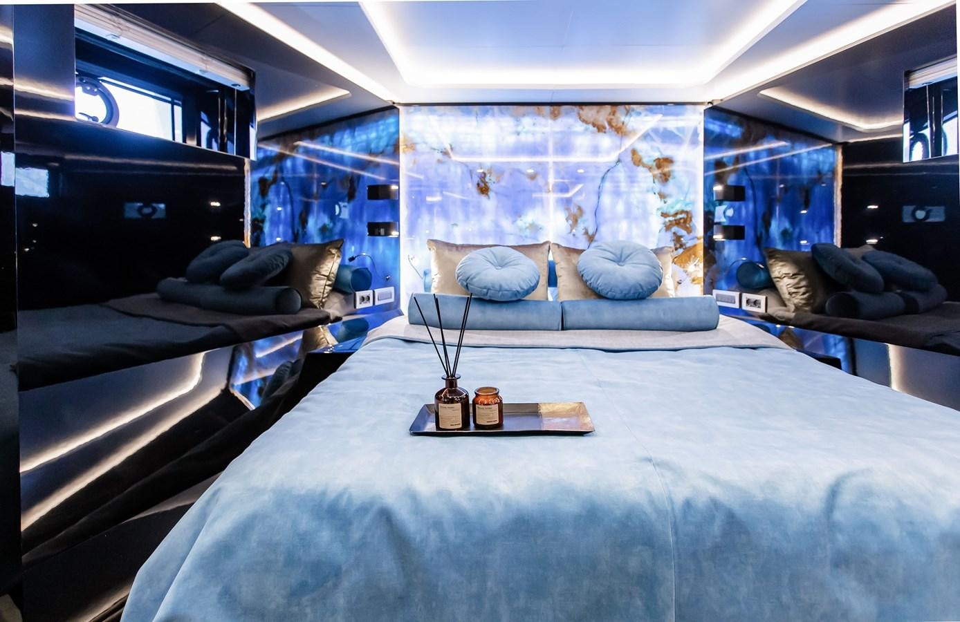 a room with a bed and a table aboard BERING 70 LEVANNA Yacht for Sale