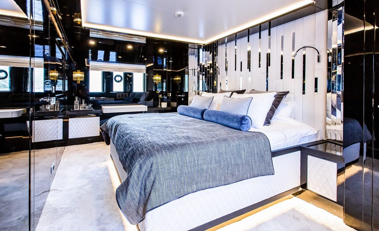 a room with a bed and a desk aboard BERING 70 LEVANNA Yacht for Sale