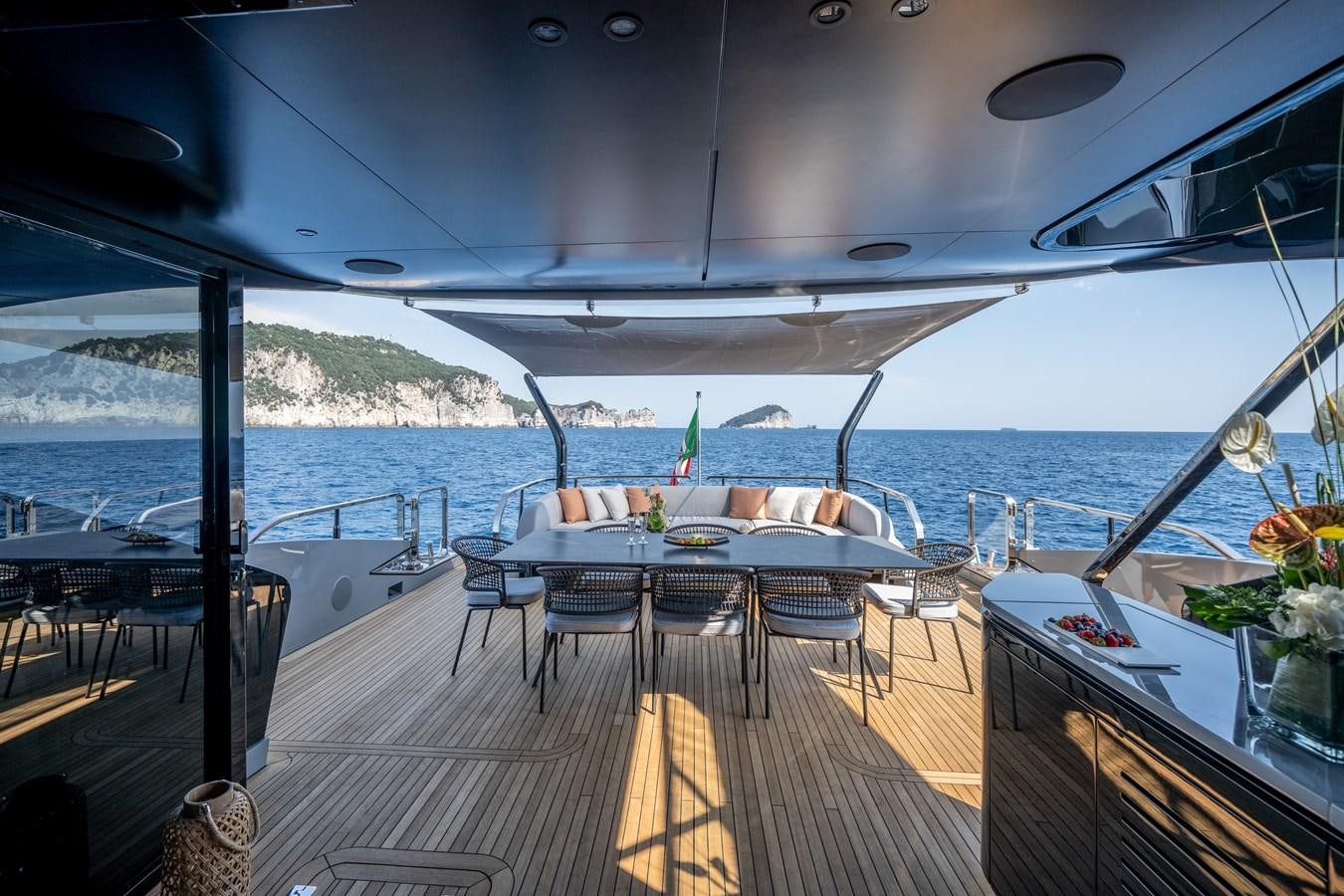 a deck with tables and chairs aboard MANGUSTA MAXIOPEN 104 REV #04 - EREIVA - CAREFULLY USED Yacht for Sale