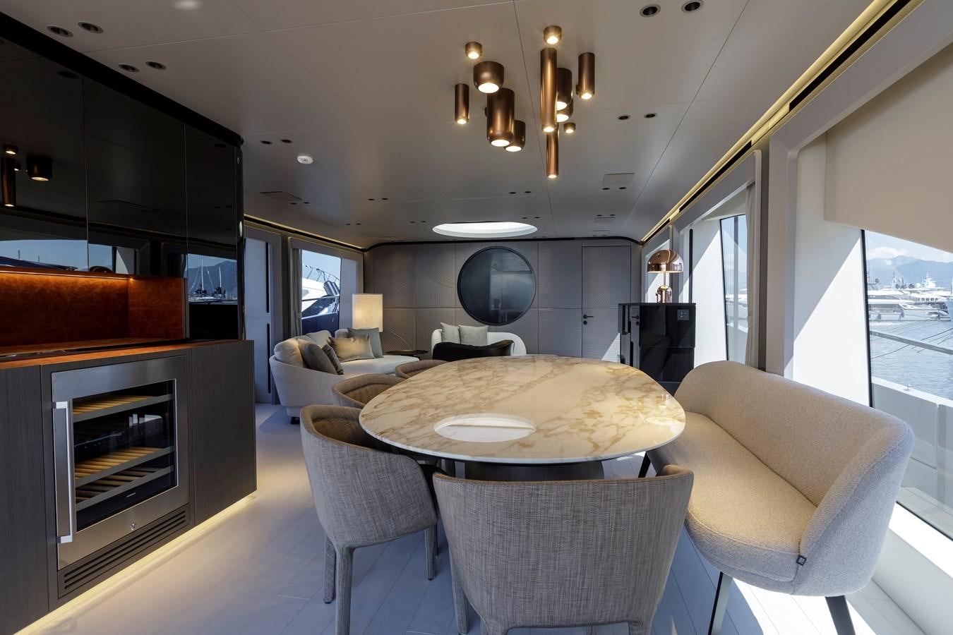 a dining room and living room aboard MANGUSTA MAXIOPEN 104 REV #04 - EREIVA - CAREFULLY USED Yacht for Sale