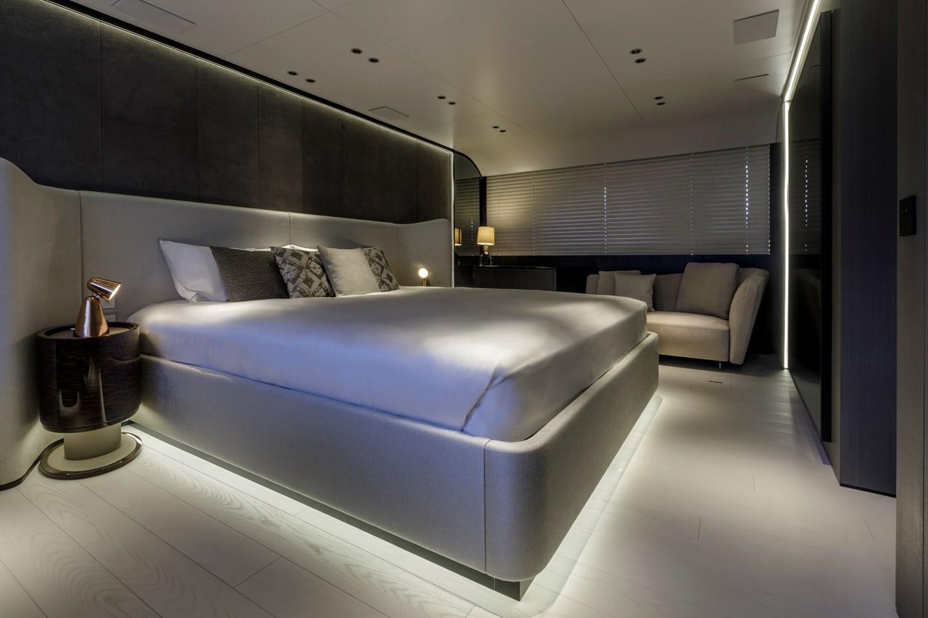 a large bed in a room aboard MANGUSTA MAXIOPEN 104 REV #04 - EREIVA - CAREFULLY USED Yacht for Sale