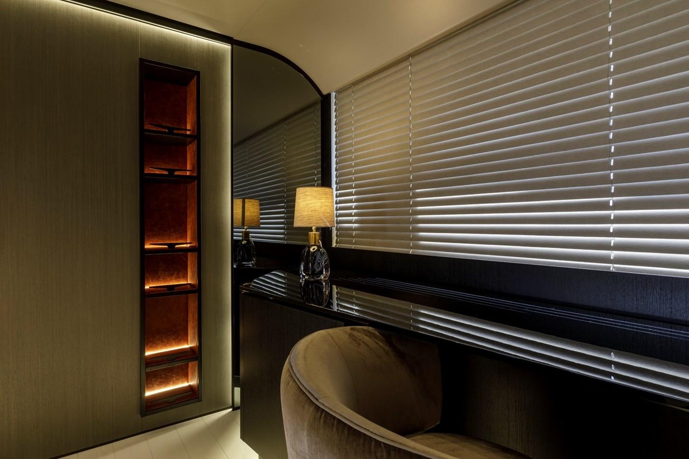 a room with a window and a chair and a shelf with books aboard MANGUSTA MAXIOPEN 104 REV #04 - EREIVA - CAREFULLY USED Yacht for Sale