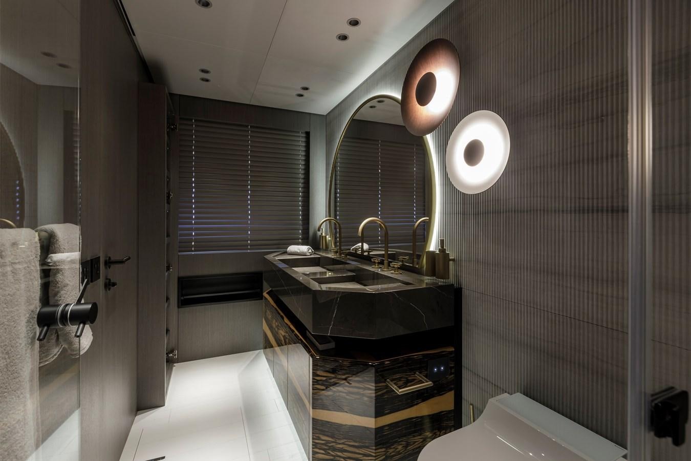 a bathroom with a large mirror aboard MANGUSTA MAXIOPEN 104 REV #04 - EREIVA - CAREFULLY USED Yacht for Sale