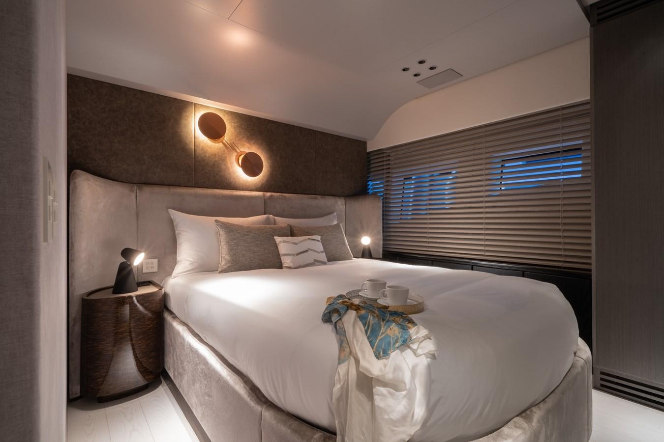a bed with a white sheet and pillows aboard MANGUSTA MAXIOPEN 104 REV #04 - EREIVA - CAREFULLY USED Yacht for Sale