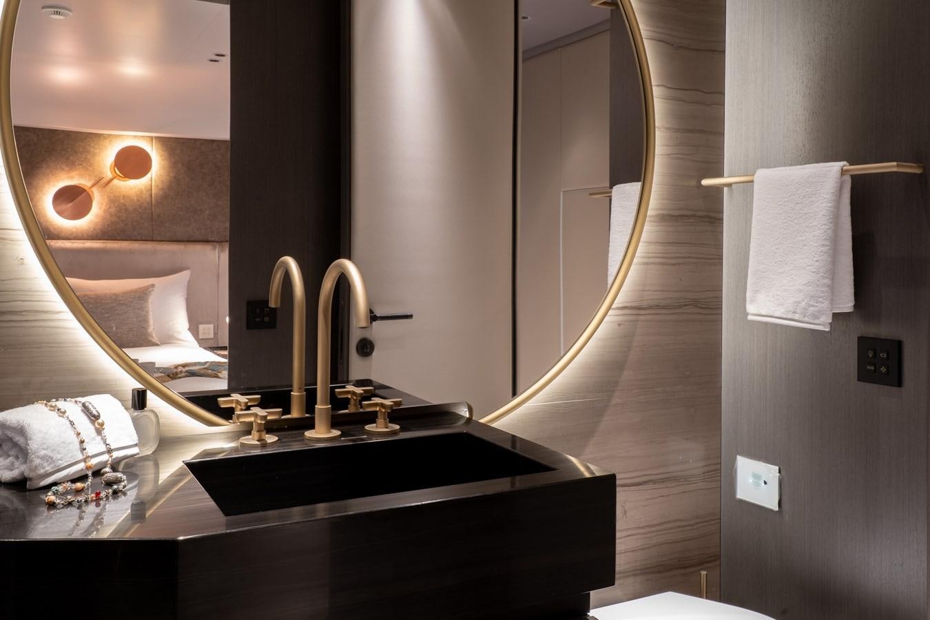 a bathroom with a large mirror aboard MANGUSTA MAXIOPEN 104 REV #04 - EREIVA - CAREFULLY USED Yacht for Sale