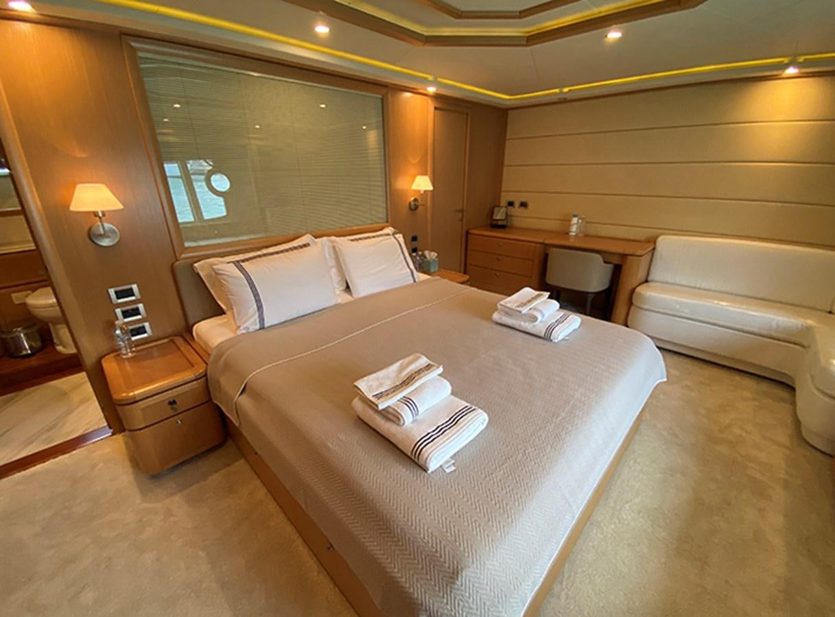 a hotel room with a bed and a desk aboard BMO Yacht for Sale