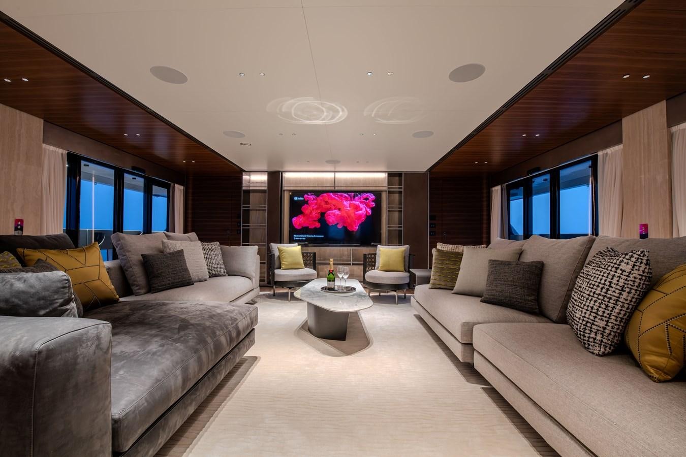 a living room with couches and a large window aboard COLUMBUS ATLANTIQUE 37/01 Yacht for Sale