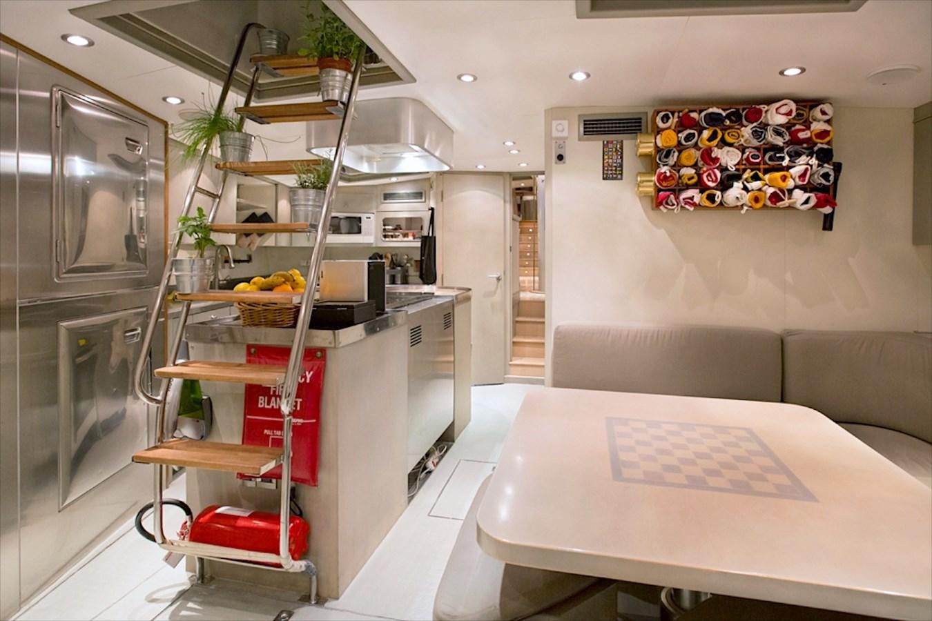 a kitchen with a table and refrigerator aboard IEMANJA Yacht for Sale