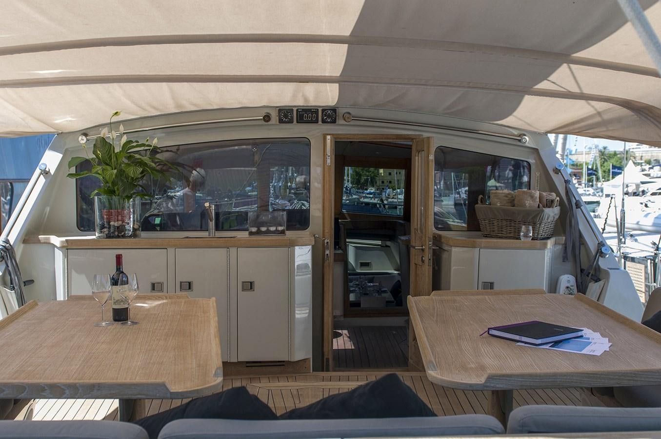 a kitchen with a table and a refrigerator aboard IEMANJA Yacht for Sale