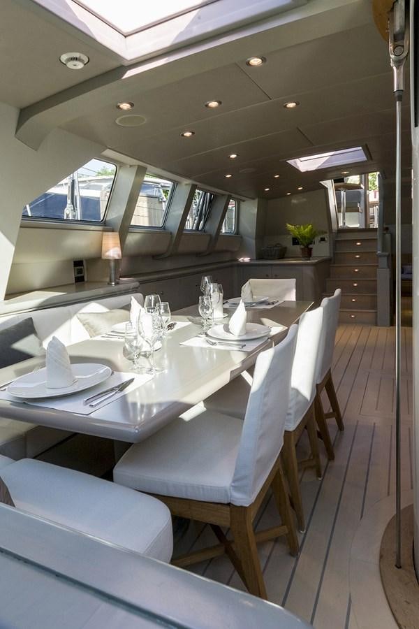 a dining table with chairs aboard IEMANJA Yacht for Sale