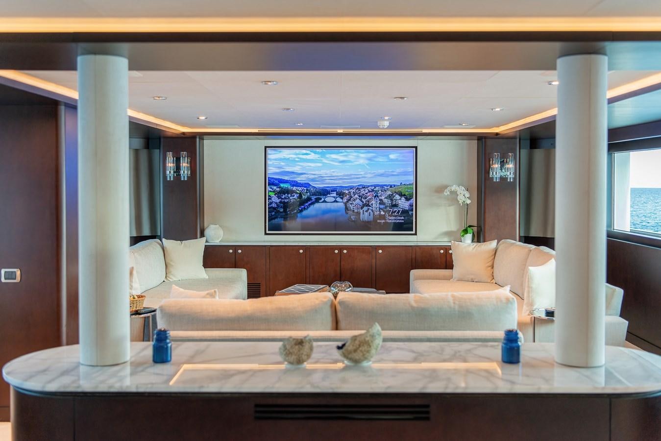 a living room with a large screen aboard KORU Yacht for Sale