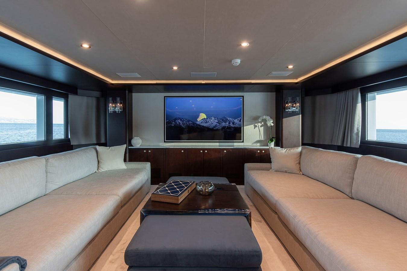 a living room with a large screen aboard KORU Yacht for Sale