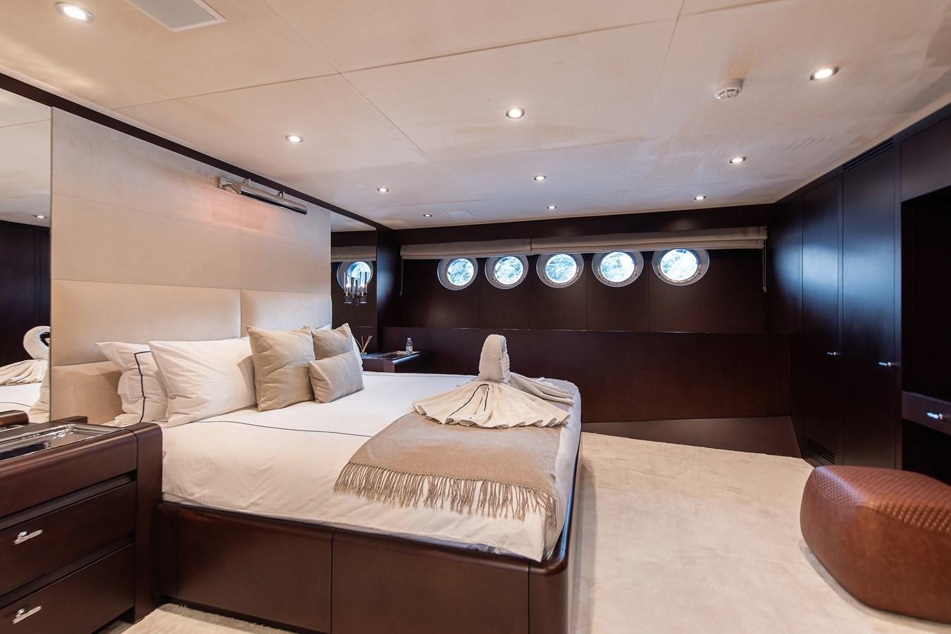 a large bed in a room aboard KORU Yacht for Sale