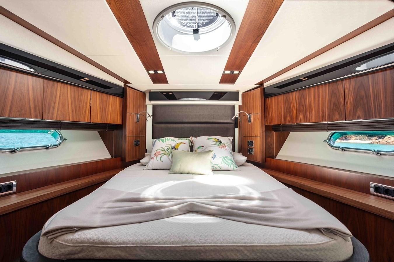 a room with a bed and a round clock aboard SARAH Yacht for Sale