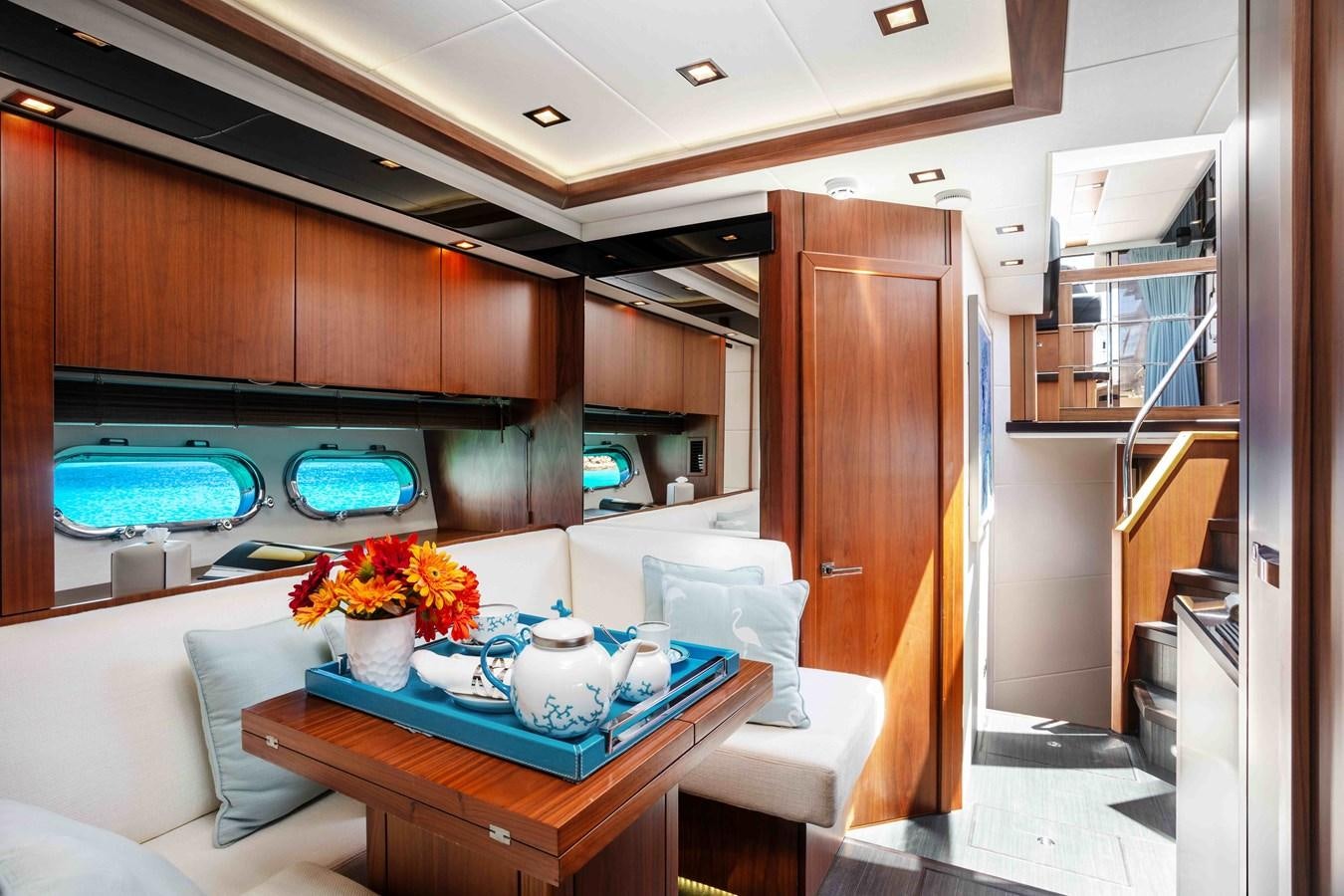 a kitchen with a table and a couch aboard SARAH Yacht for Sale