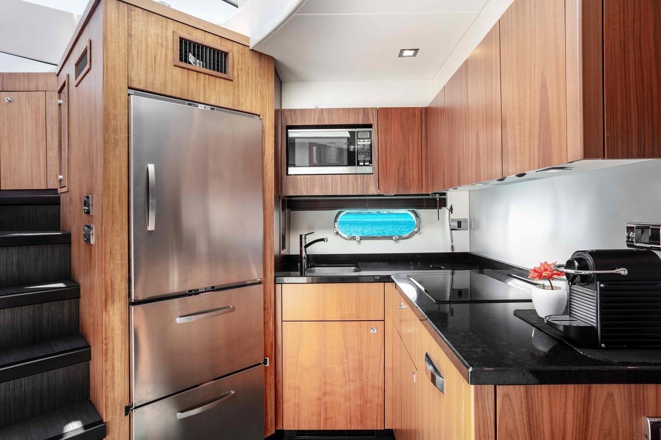 a kitchen with wooden cabinets aboard SARAH Yacht for Sale