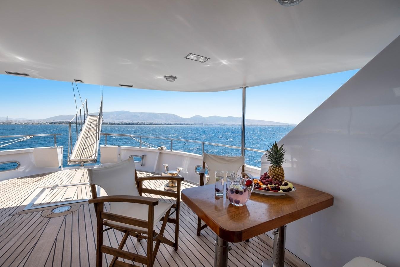 a table and chairs on a balcony aboard ATHINA Yacht for Sale