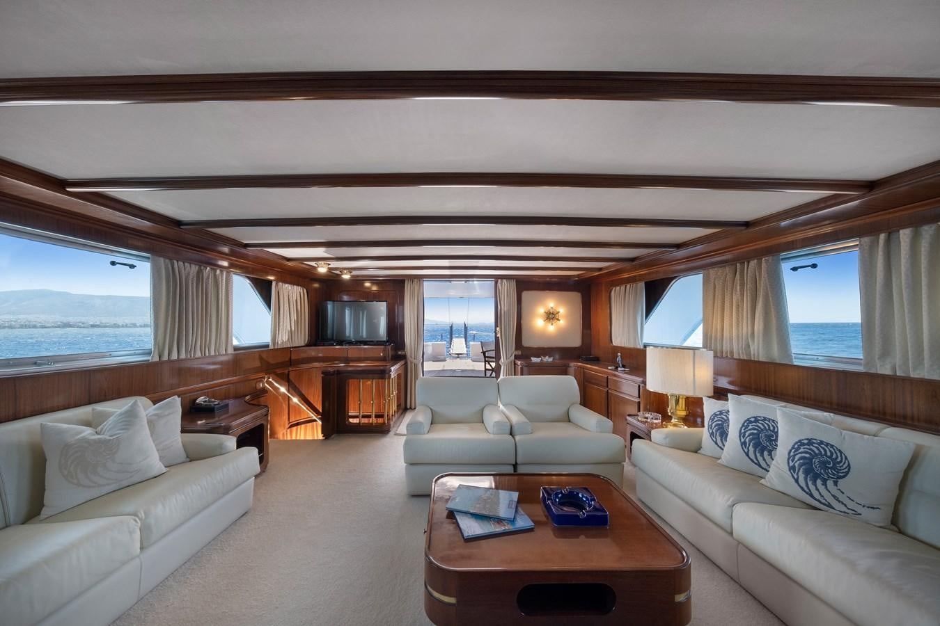 a living room with a couch and a television aboard ATHINA Yacht for Sale