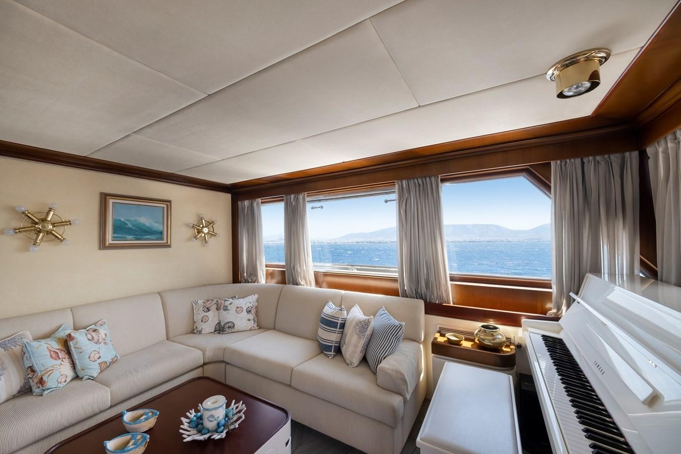 a living room with a piano aboard ATHINA Yacht for Sale