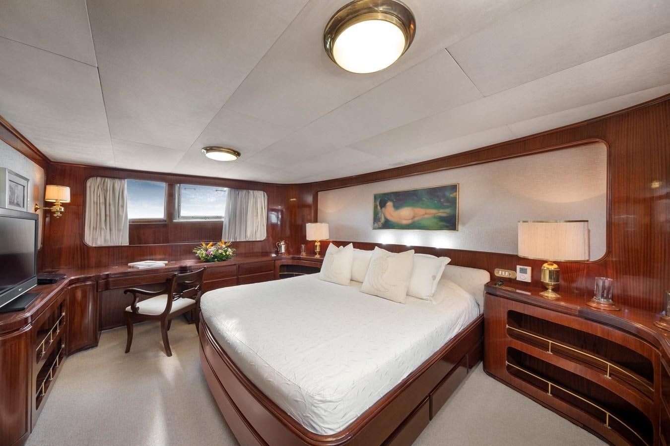 a hotel room with a bed and desk aboard ATHINA Yacht for Sale