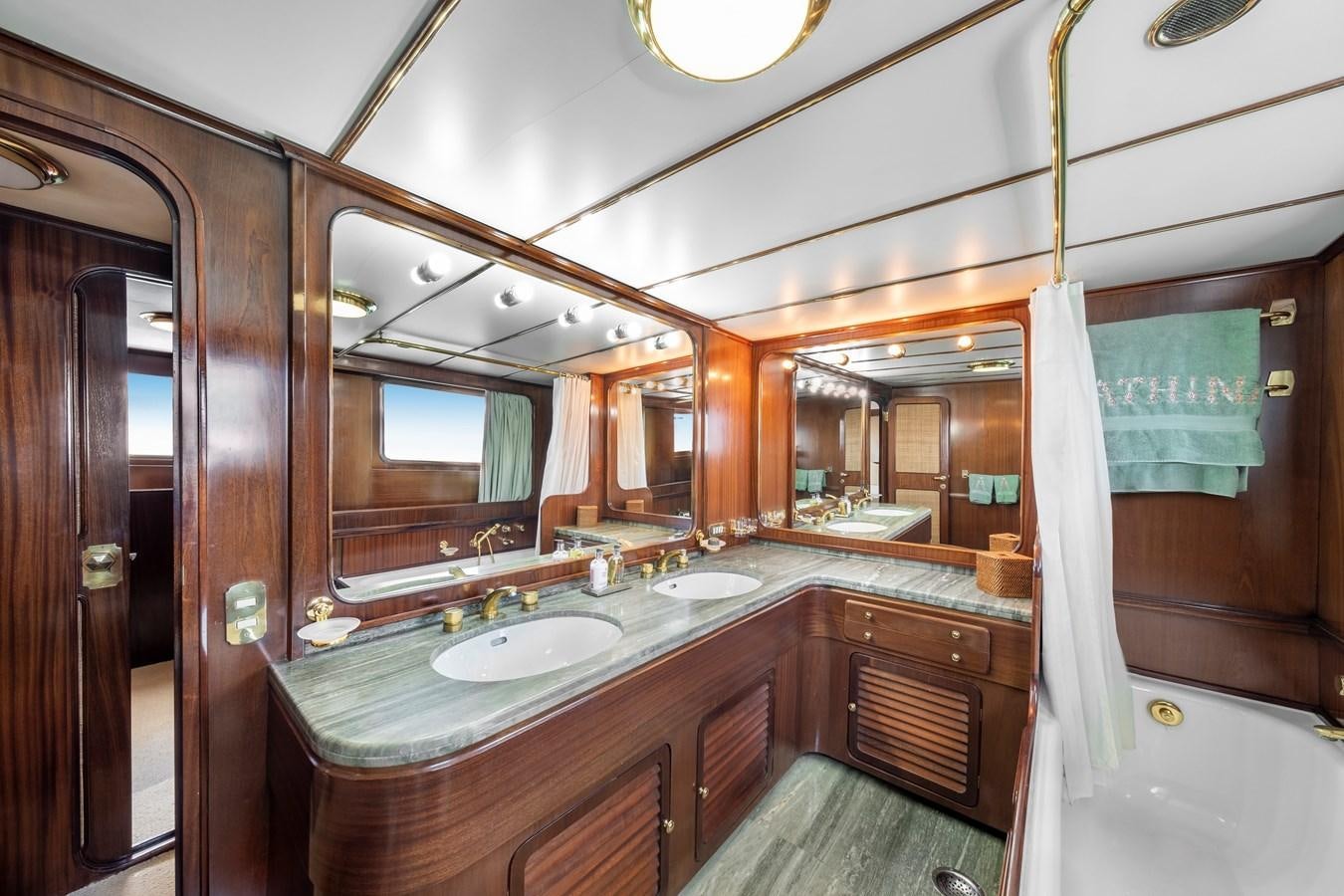 a bathroom with a large mirror aboard ATHINA Yacht for Sale