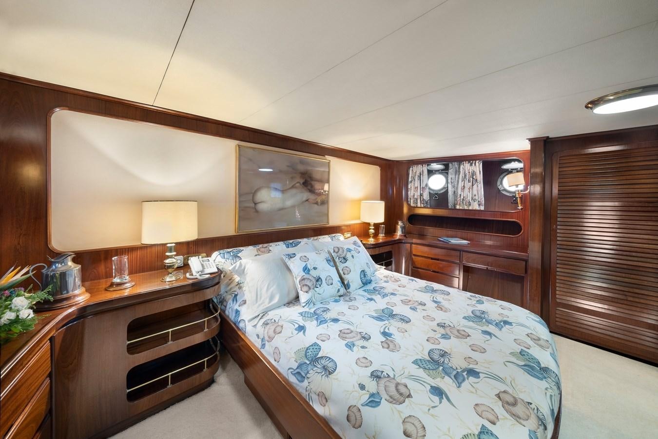 a bedroom with a bed and a desk aboard ATHINA Yacht for Sale