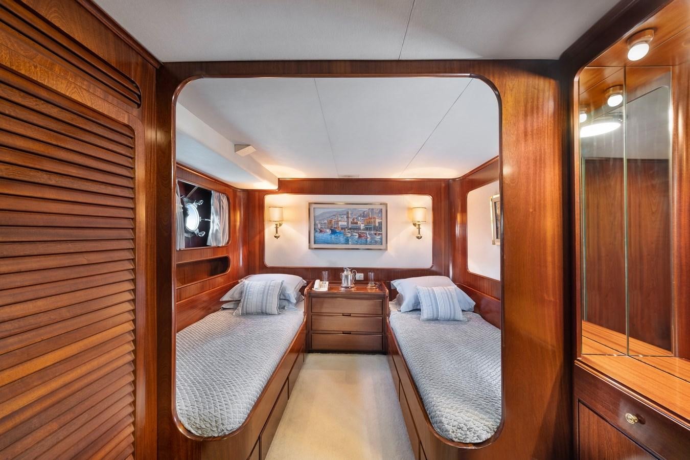 a room with a bed and a mirror aboard ATHINA Yacht for Sale