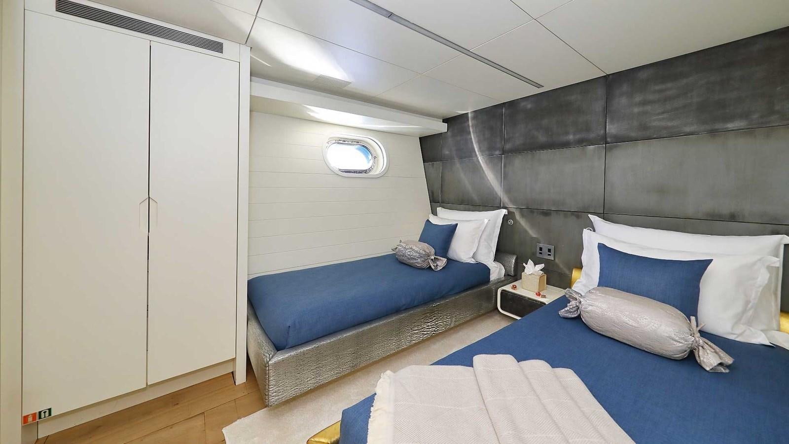 a room with a bed and a blue bed aboard ANAVI Yacht for Sale