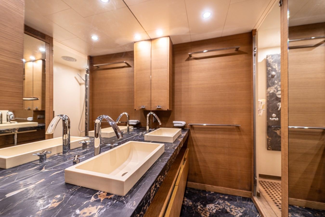a bathroom with a sink and a shower aboard LEONARDO Yacht for Sale