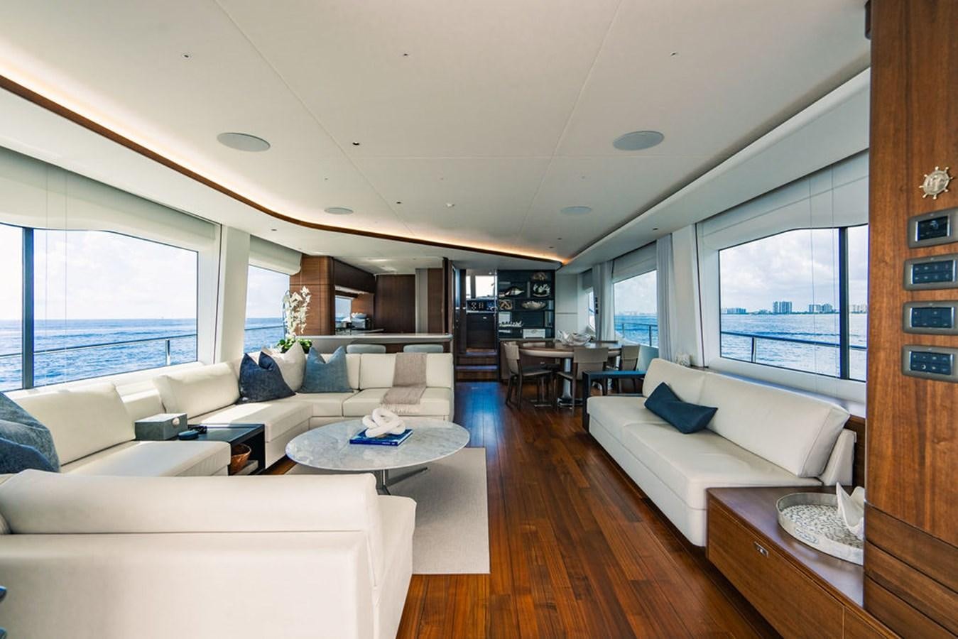 a living room with a couch and a table aboard TBANK Yacht for Sale
