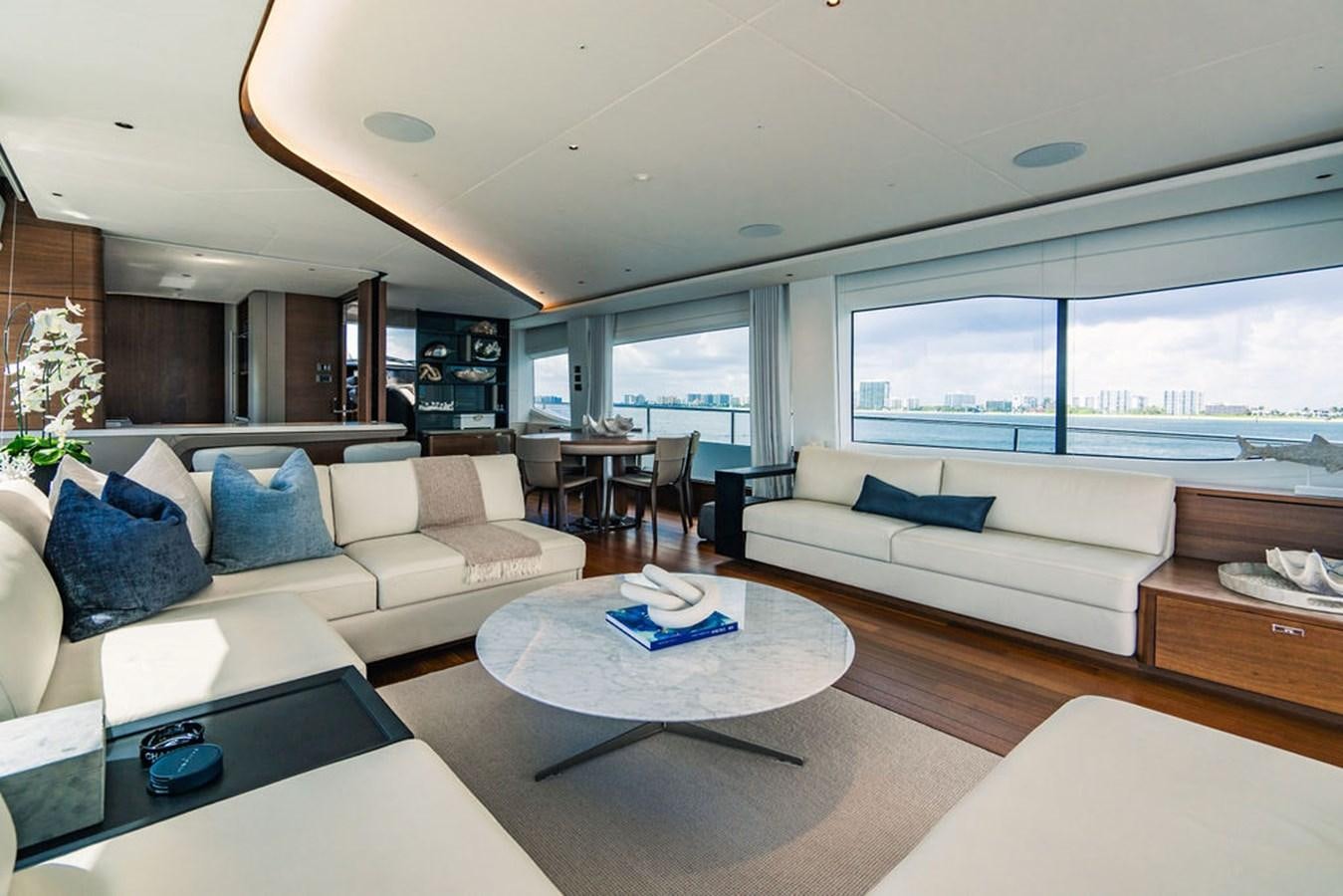 a living room with a couch and a table aboard TBANK Yacht for Sale