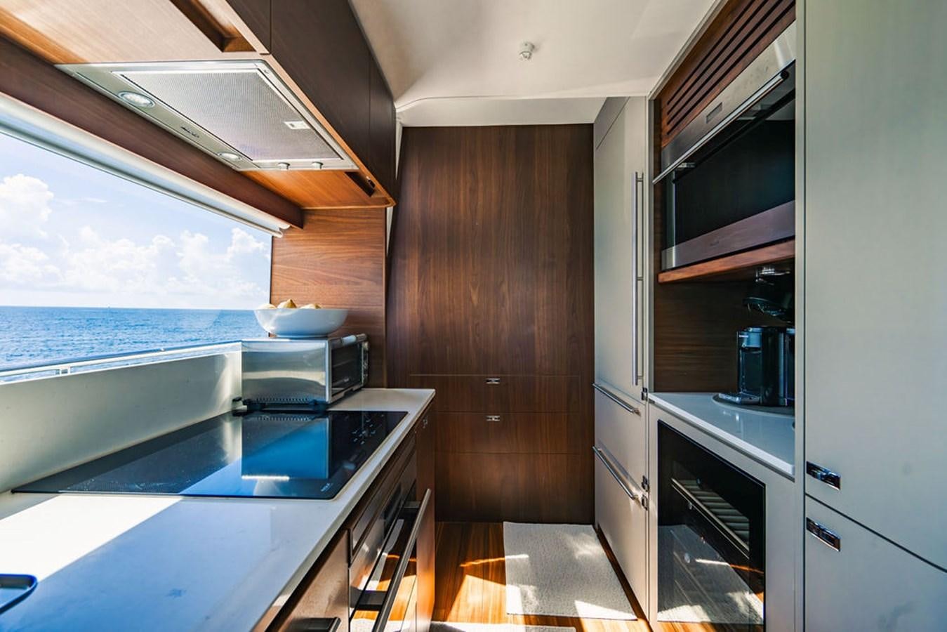 a kitchen with a large window aboard TBANK Yacht for Sale
