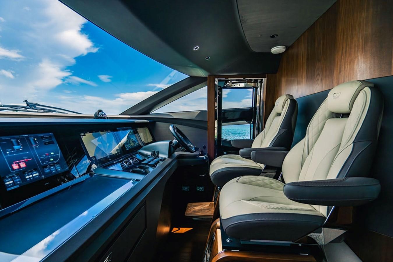 inside of a vehicle with seats and a view of the outside and the cockpit and the seats and aboard TBANK Yacht for Sale