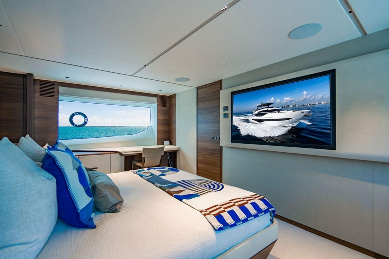 a room with a bed and a tv on the wall aboard TBANK Yacht for Sale