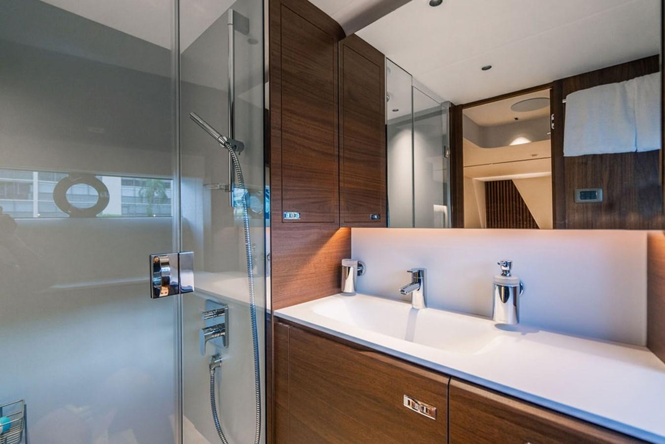 a bathroom with a glass shower aboard TBANK Yacht for Sale