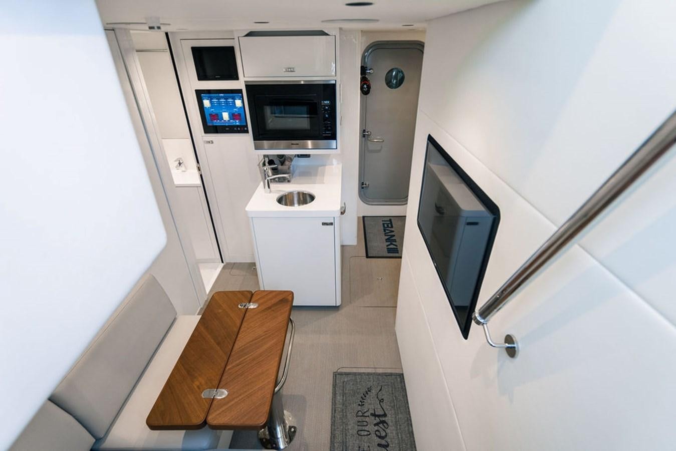 a small kitchen with a microwave oven aboard TBANK Yacht for Sale