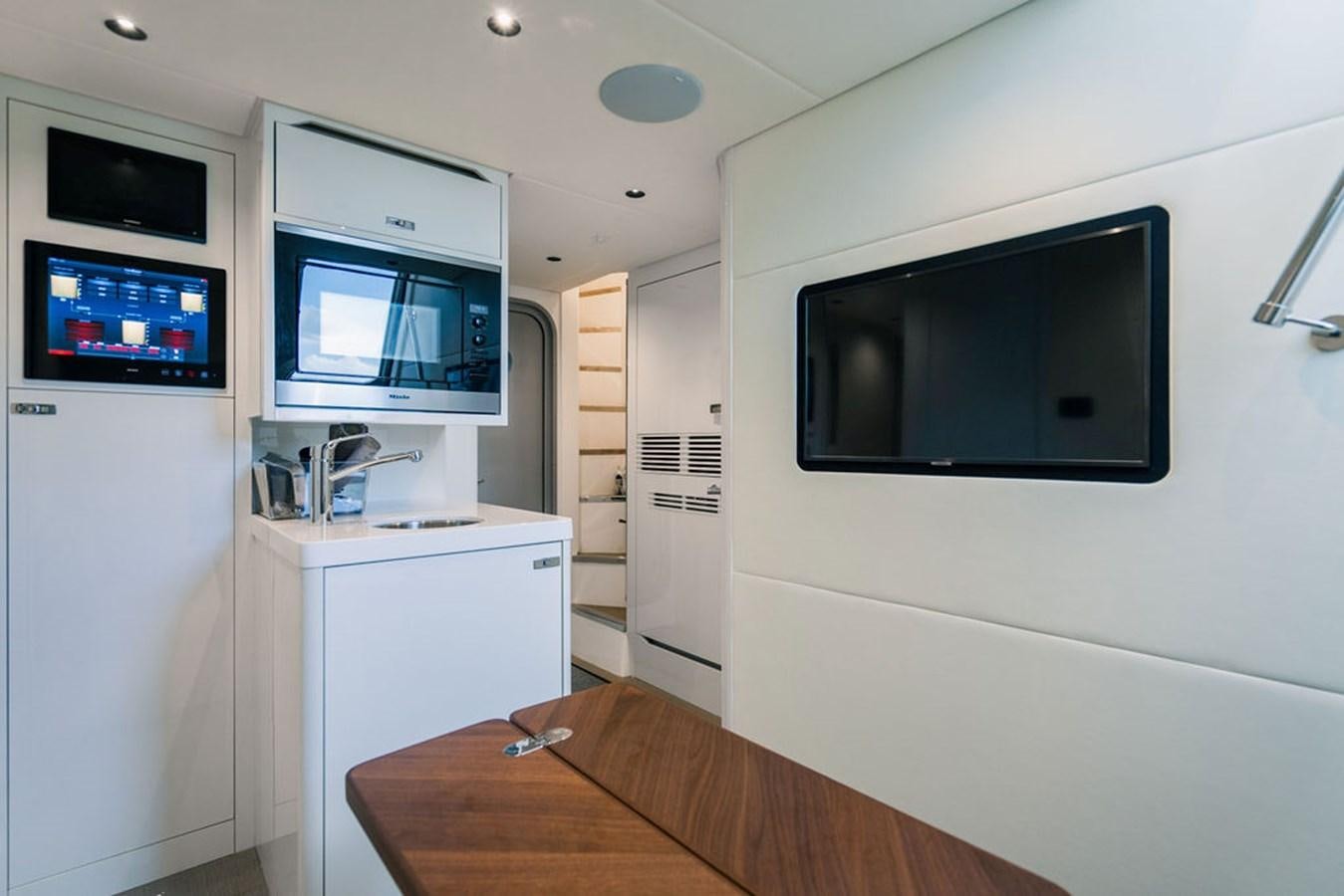 a room with a desk and tv aboard TBANK Yacht for Sale