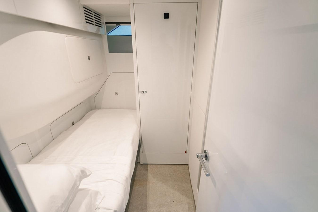 a room with a bed and a window aboard TBANK Yacht for Sale