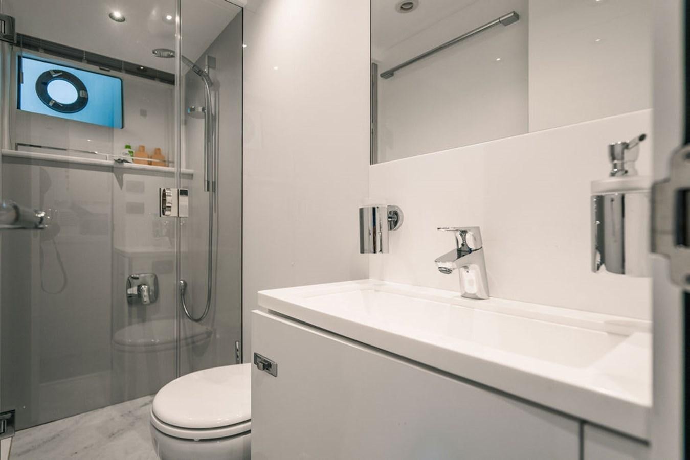 a bathroom with a glass shower aboard TBANK Yacht for Sale