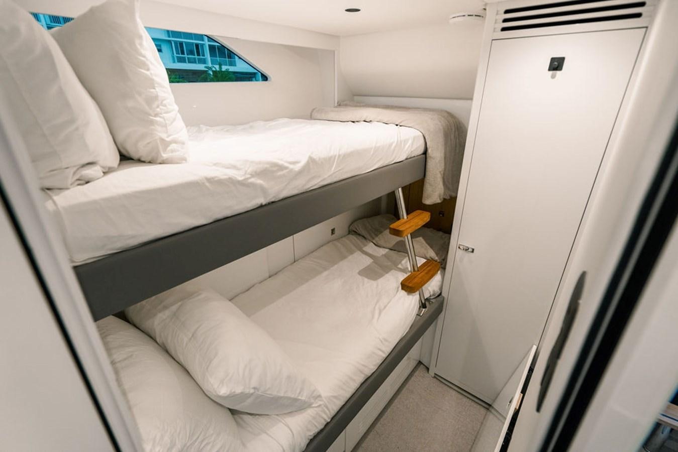a room with white beds aboard TBANK Yacht for Sale