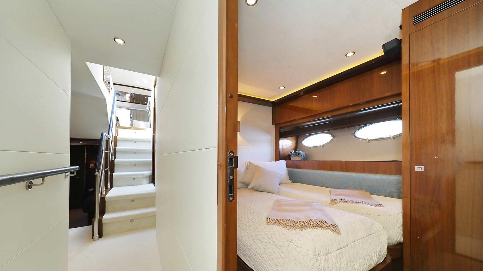 a bedroom with a bed and a staircase aboard AGAVE Yacht for Sale